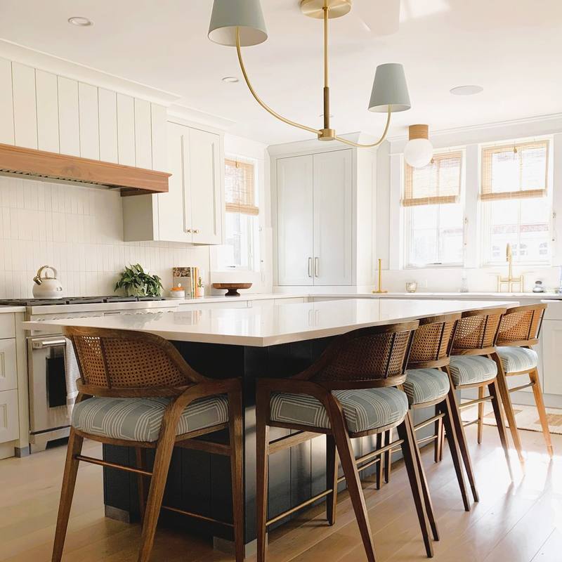 Kitchen with sage island and brass fixtures